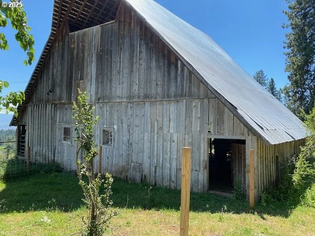 a backyard of a house with potted plants and wooden fence