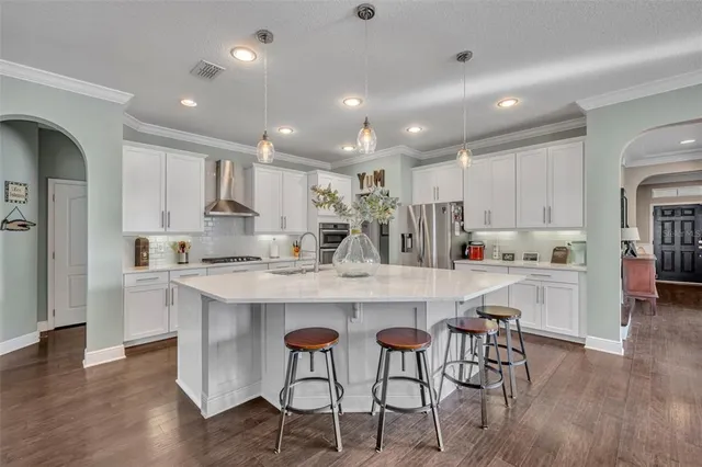 a kitchen with kitchen island cabinets and chairs