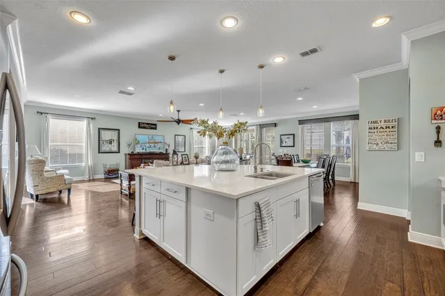 a large kitchen with stainless steel appliances a lot of counter space and wooden floor