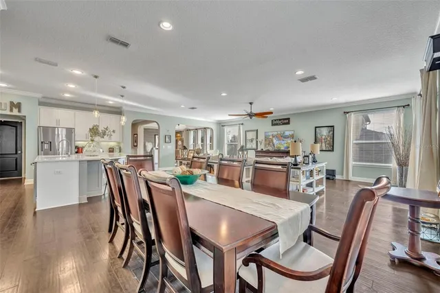 a dining room with furniture and wooden floor