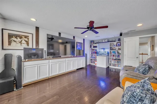 a living room with furniture and kitchen view