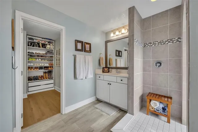 a spacious bathroom with a double vanity sink and a mirror