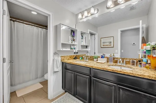 a view of a room with wooden floor and a ceiling fan