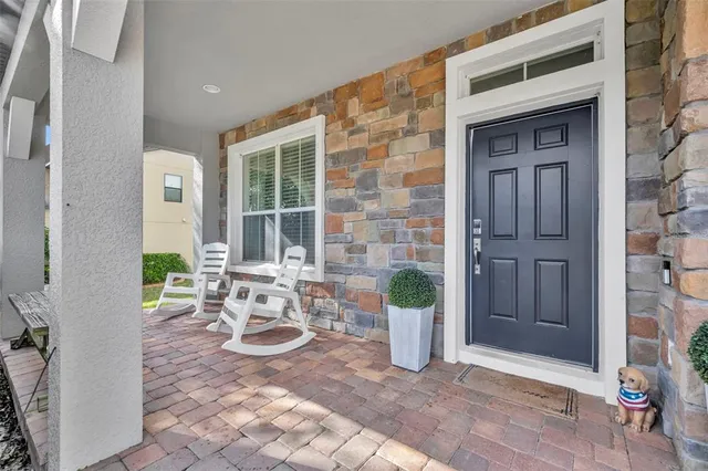 a view of a patio with table and chairs and potted plants