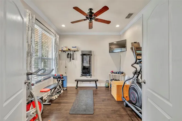 a view of a livingroom with furniture and gym equipment