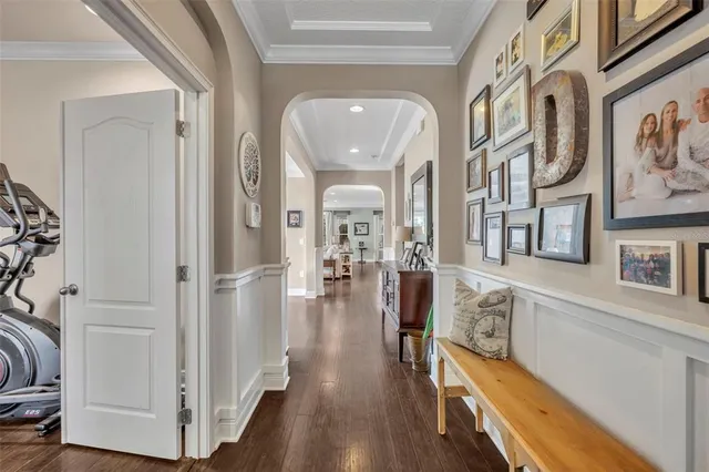 a view of a hallway with entryway and wooden floor