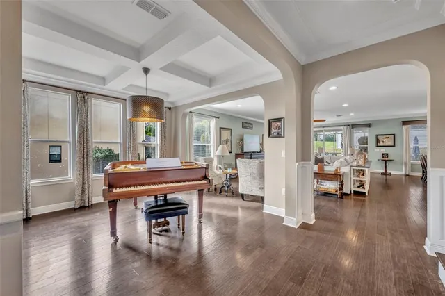 a living room with furniture a table and wooden floor