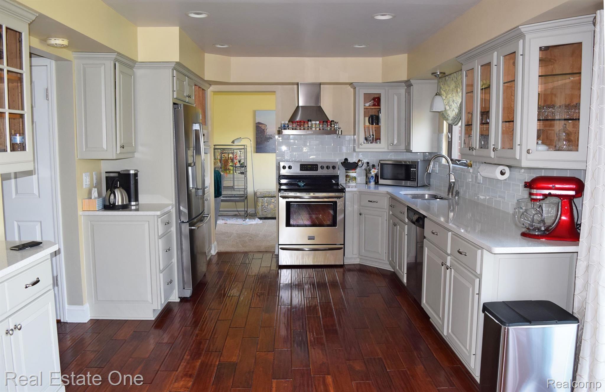 Beautifully updated kitchen with lots of Quartz counters, Stainless appliances and a real teak floor. 
