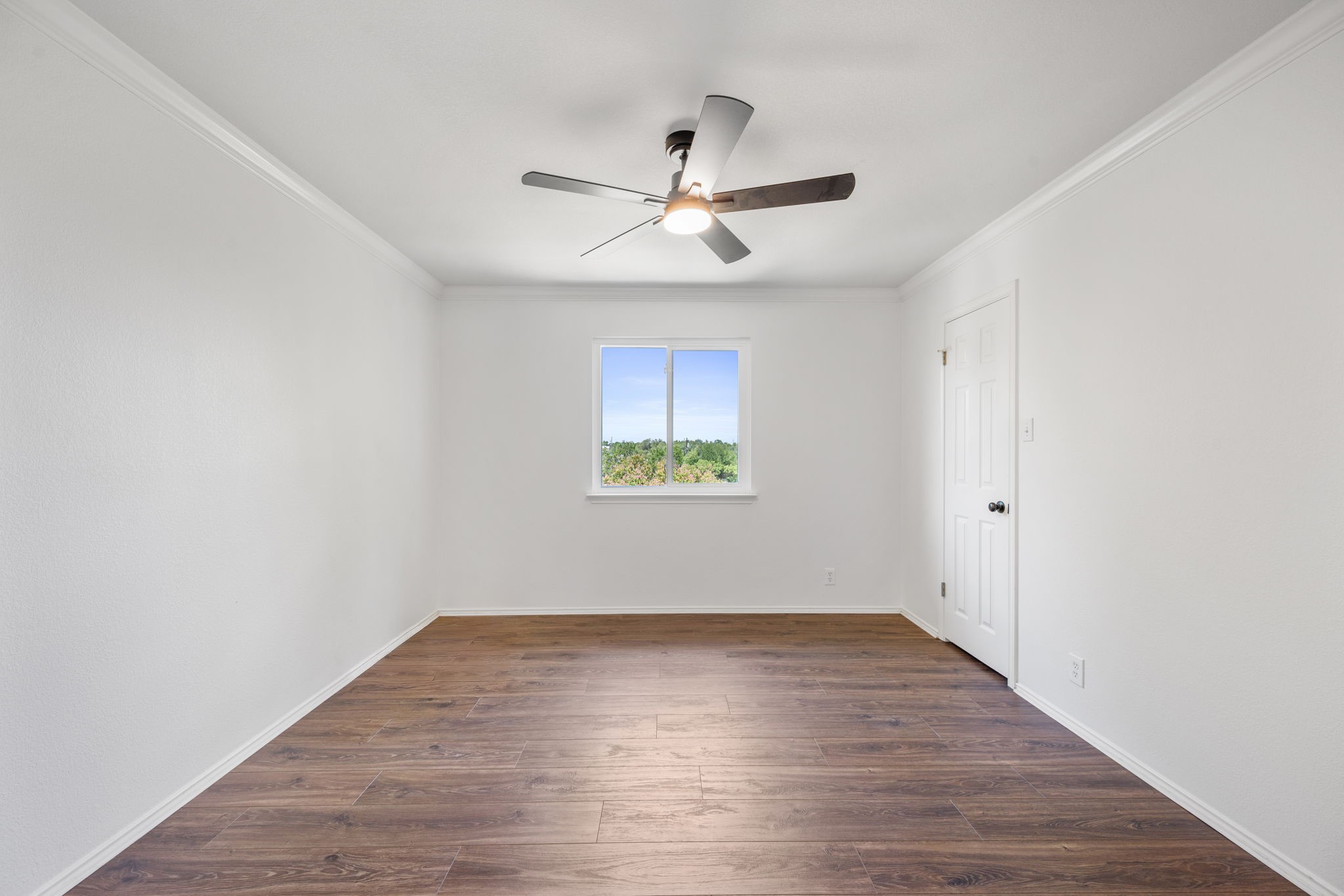 2440 Madeline Loop Cedar Park, TX 78613 - Photo 22 of 33 Spare room featuring dark wood-style flooring, crown molding, and ceiling fan