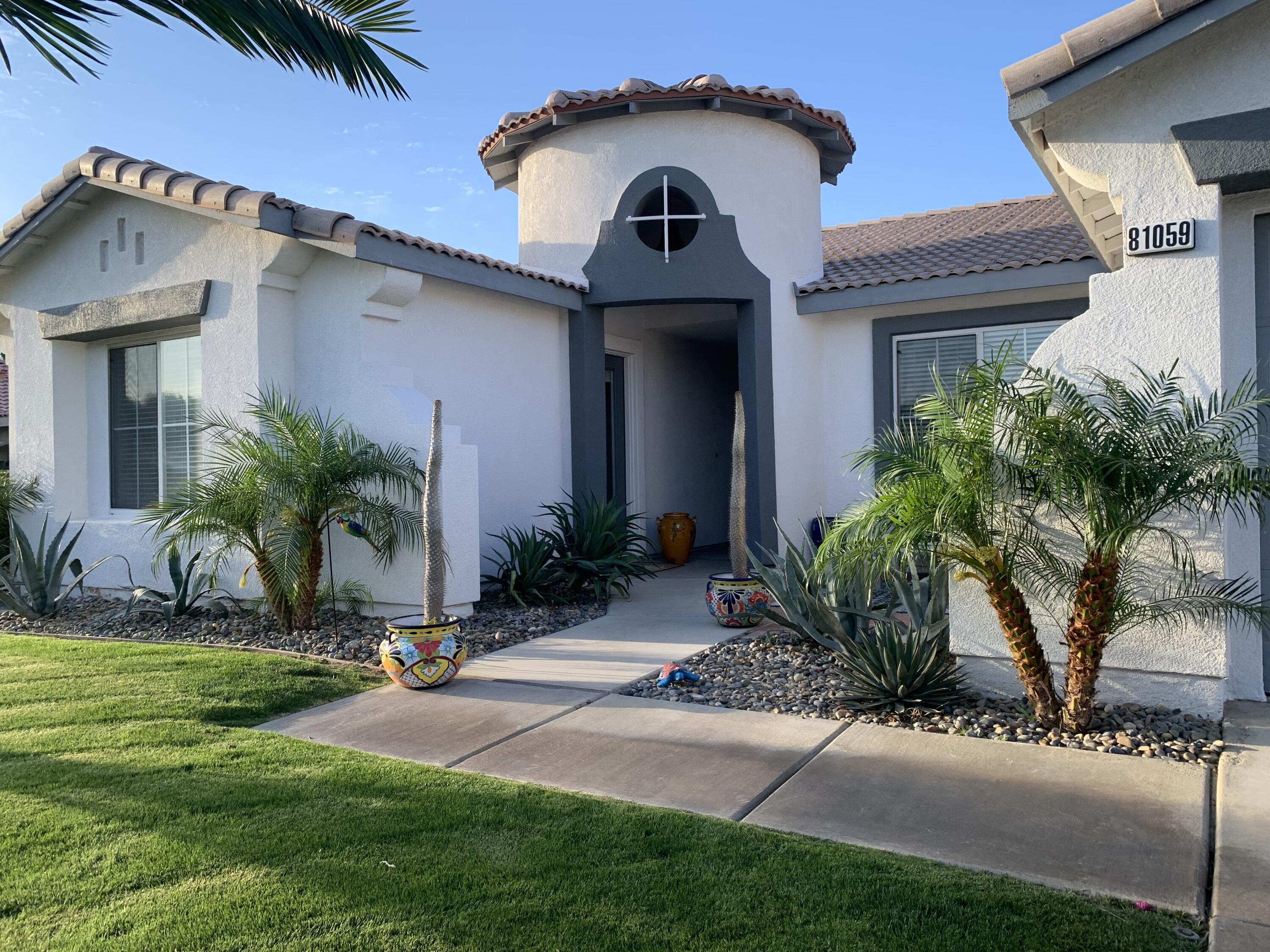 81059 Aurora Avenue Indio, CA 92201 - Photo 1 of 26 a front view of a house with a yard