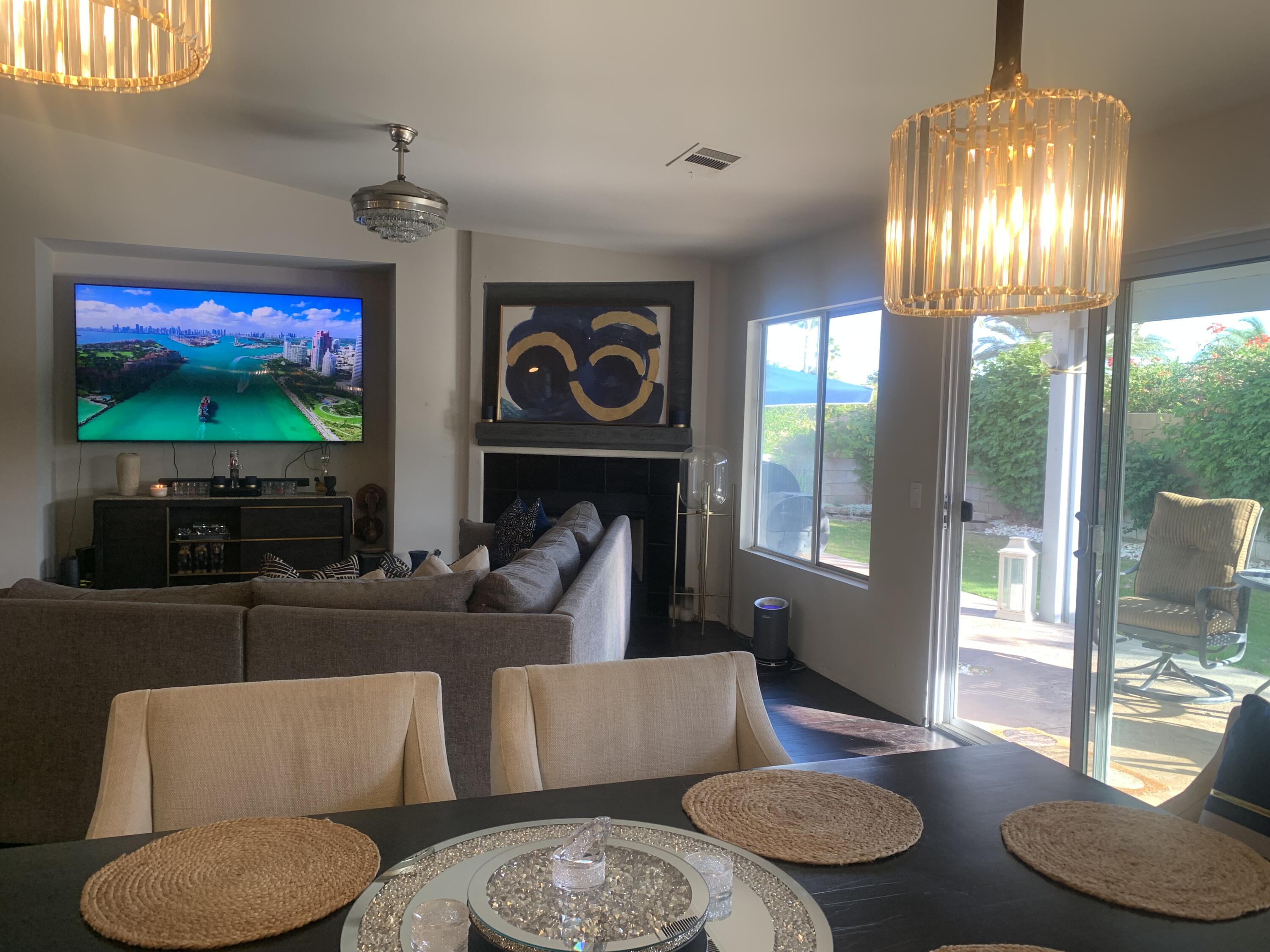 81059 Aurora Avenue Indio, CA 92201 - Photo 13 of 26 a living room with furniture and a flat screen tv
