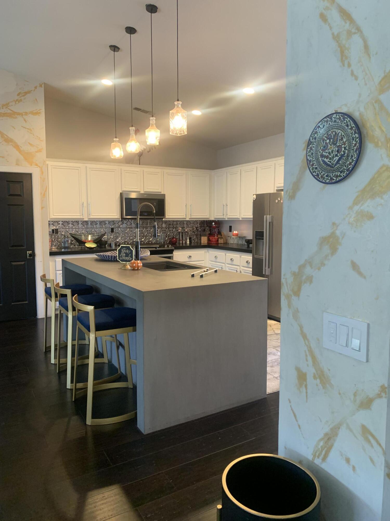 81059 Aurora Avenue Indio, CA 92201 - Photo 16 of 26 a kitchen with kitchen island a dining table chairs and a sink