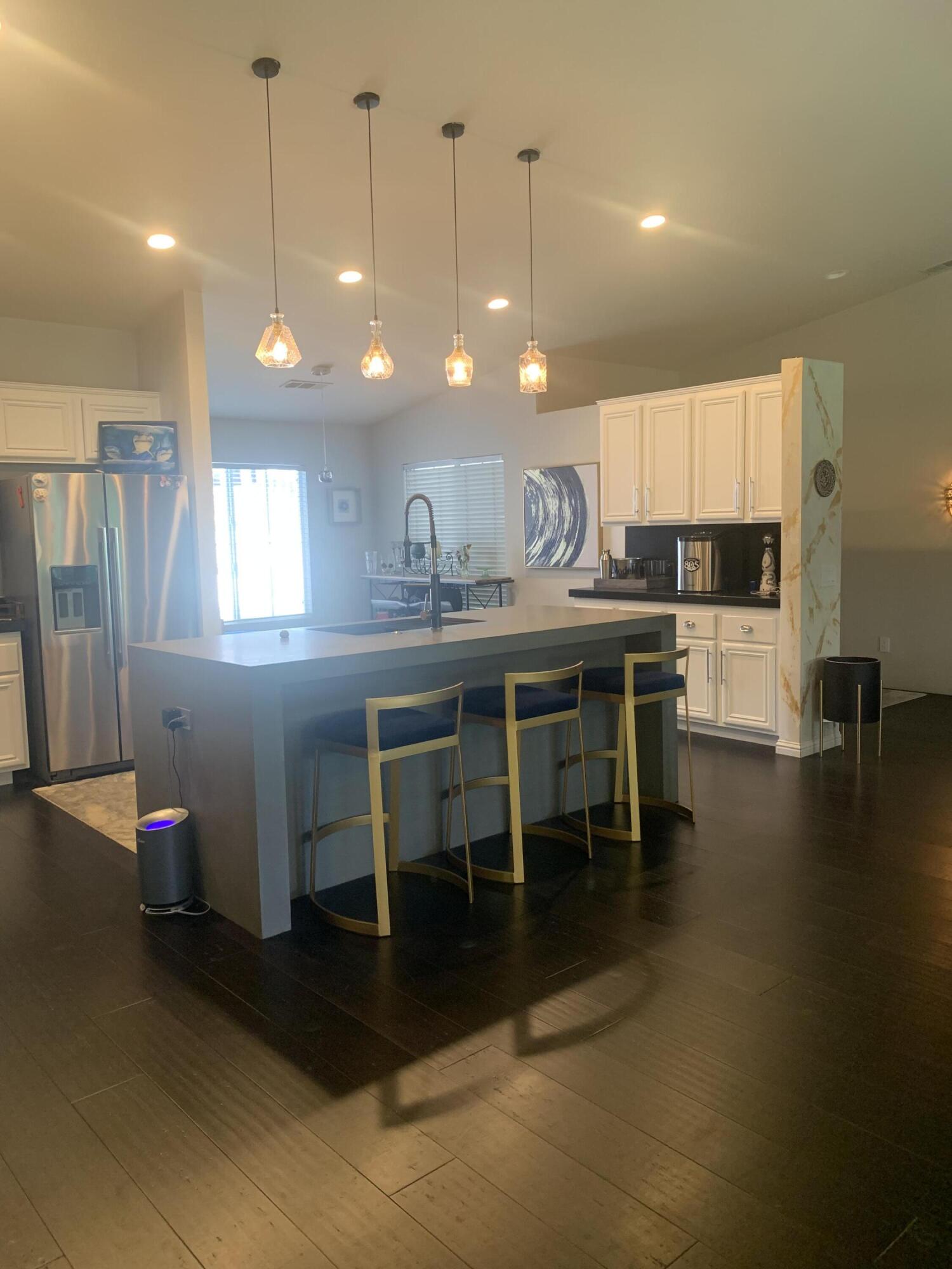 81059 Aurora Avenue Indio, CA 92201 - Photo 21 of 26 a kitchen with lots of counter space dining table and chairs