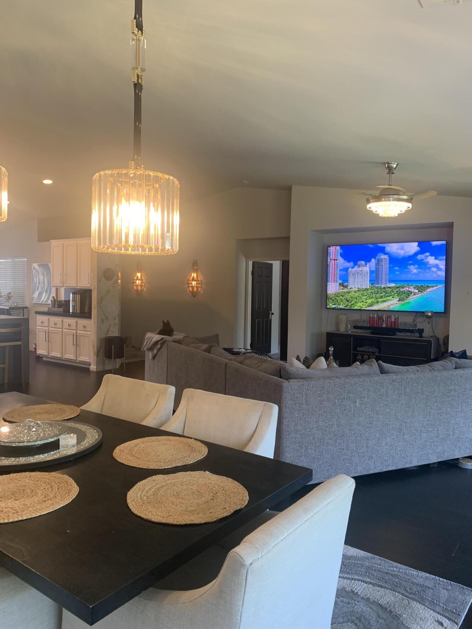 81059 Aurora Avenue Indio, CA 92201 - Photo 26 of 26 a living room with furniture a lamp and a chandelier