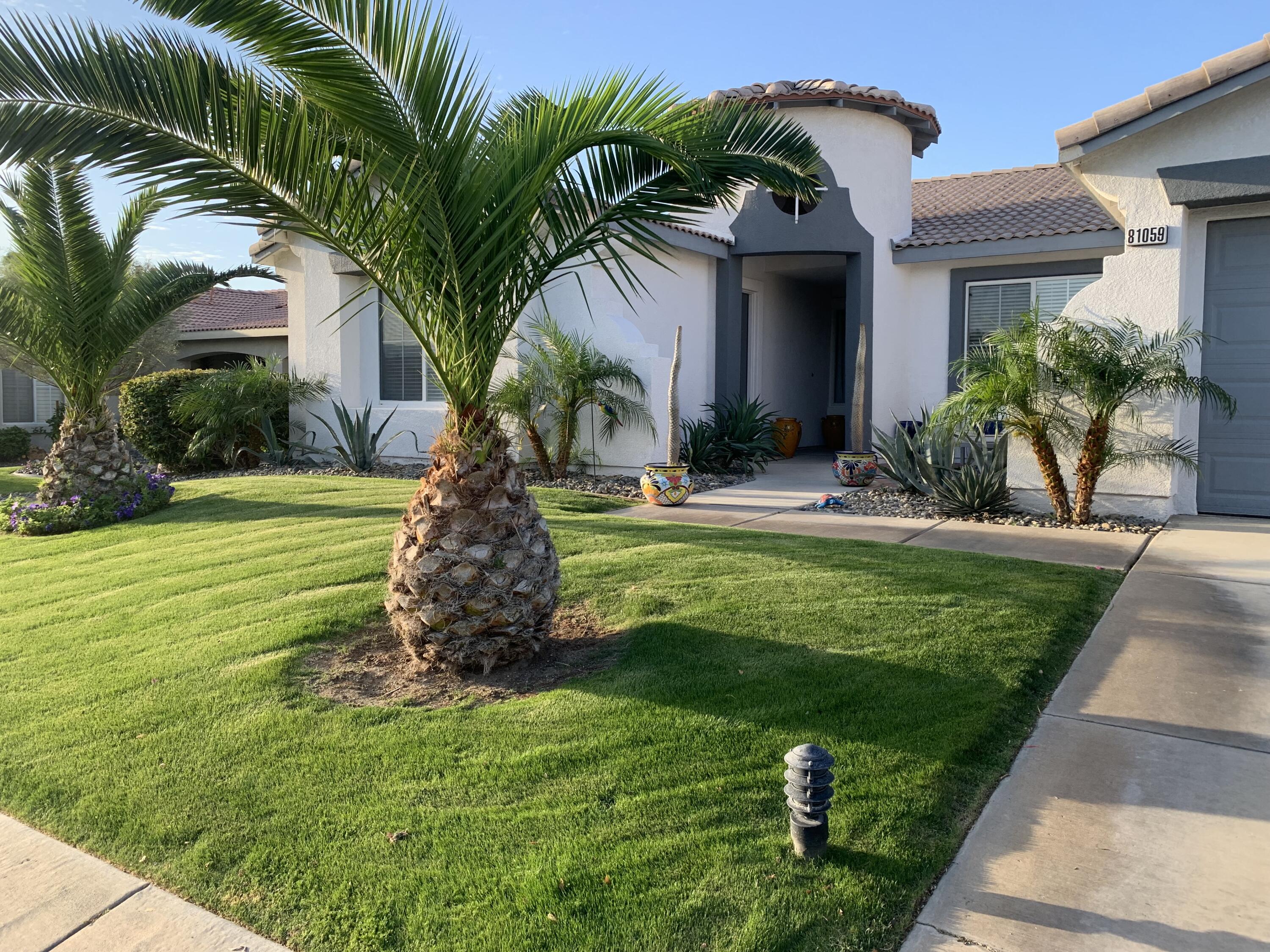 81059 Aurora Avenue Indio, CA 92201 - Photo 3 of 26 a front view of a house with garden