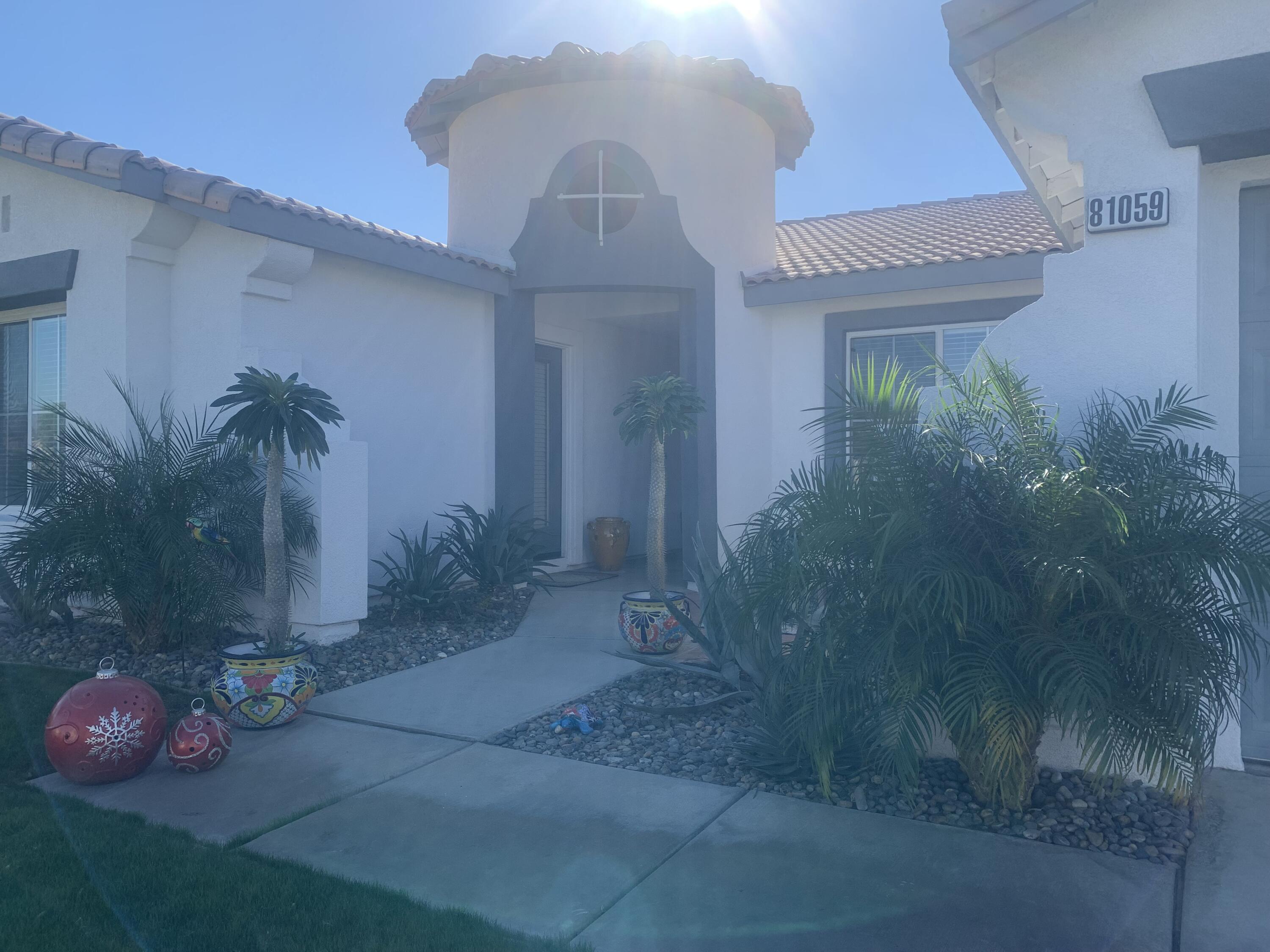 81059 Aurora Avenue Indio, CA 92201 - Photo 6 of 26 a front view of a house with plants