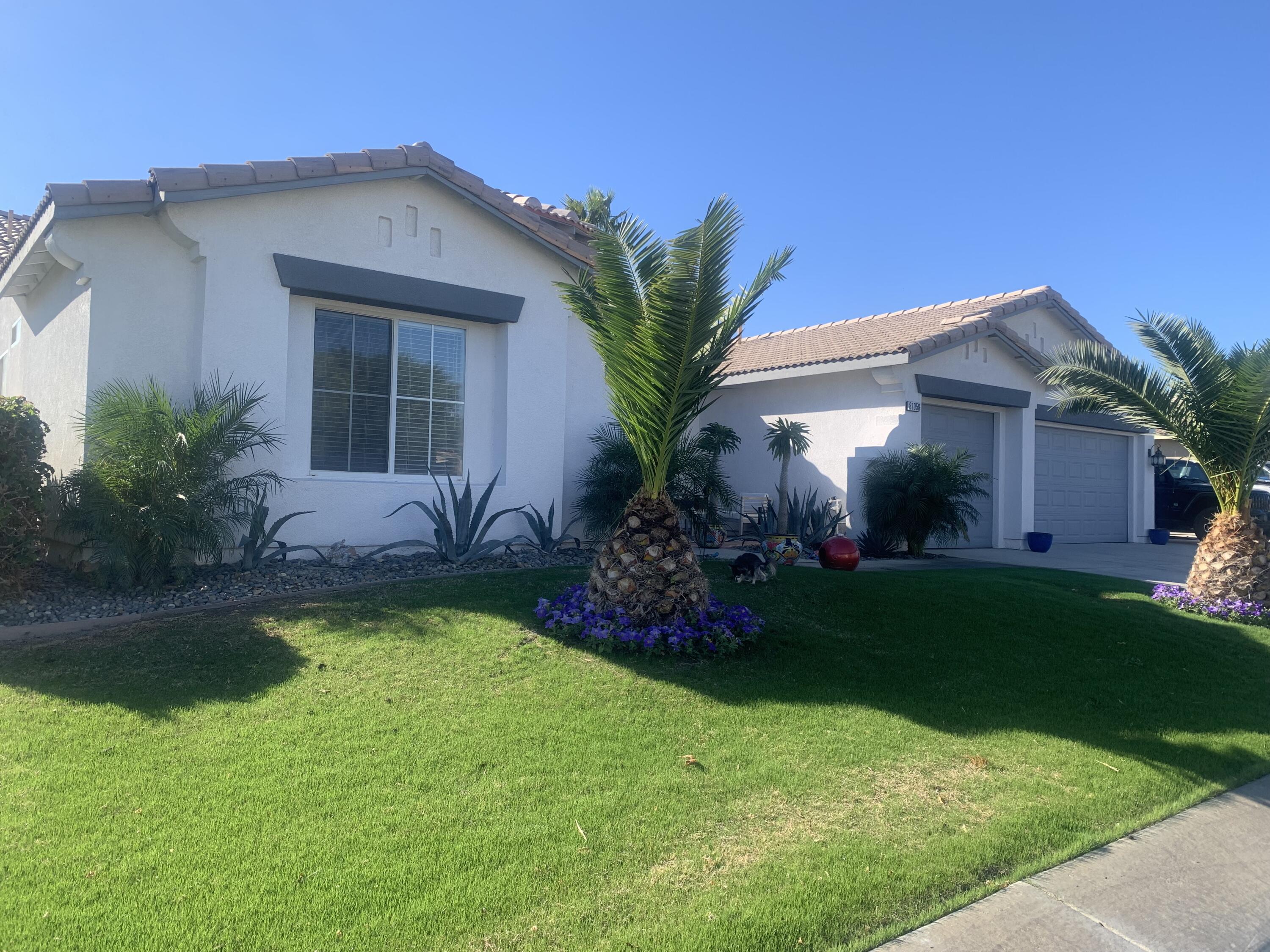 81059 Aurora Avenue Indio, CA 92201 - Photo 7 of 26 a front view of a house with garden