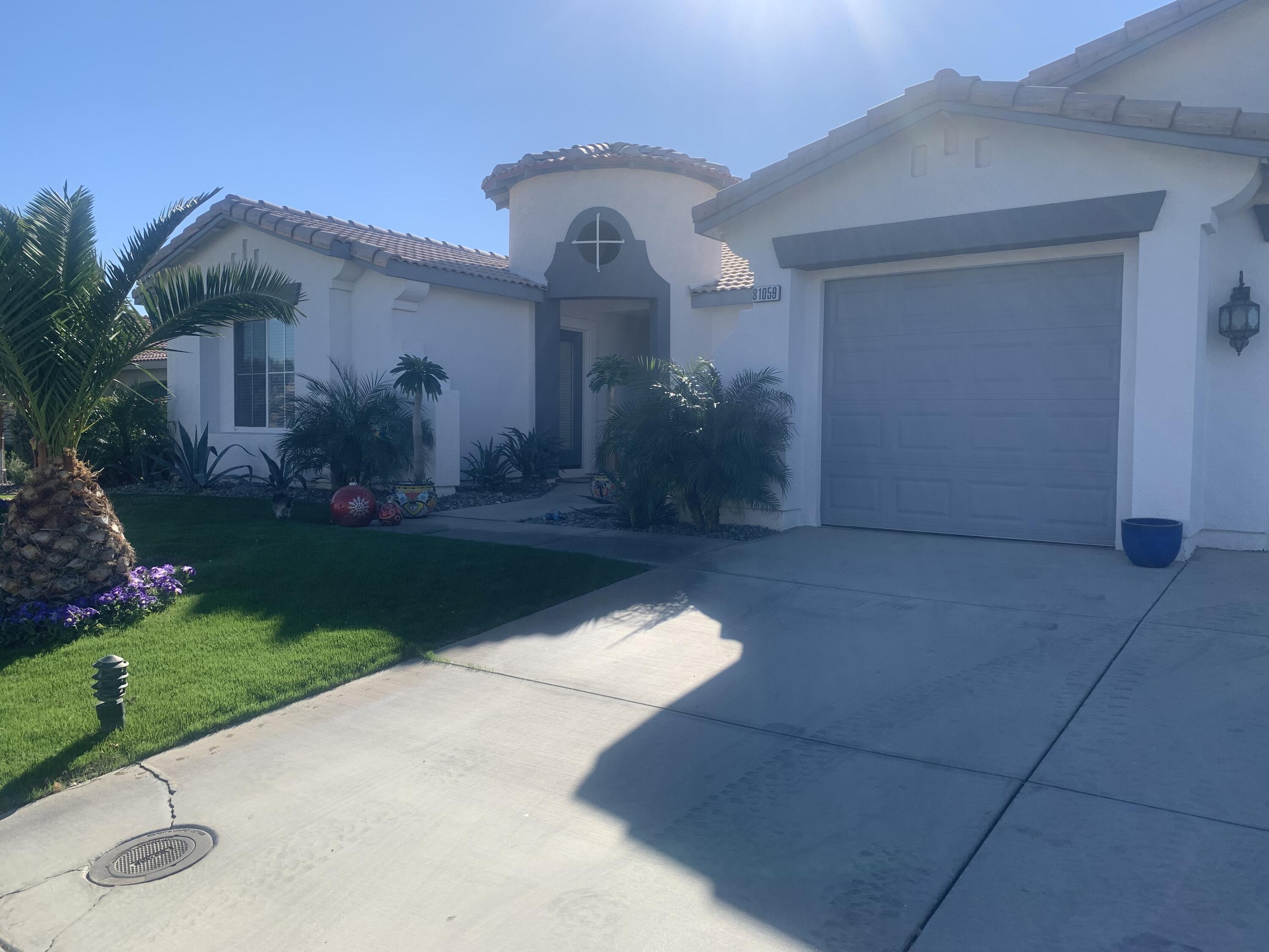 81059 Aurora Avenue Indio, CA 92201 - Photo 9 of 26 a front view of house with garden