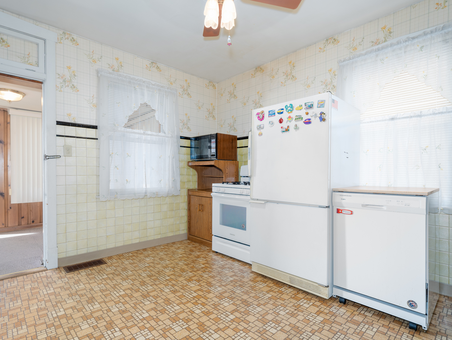 4949 West Deming Place Chicago, IL 60639 - Photo 5 of 18 a white refrigerator freezer and a stove sitting inside of a kitchen