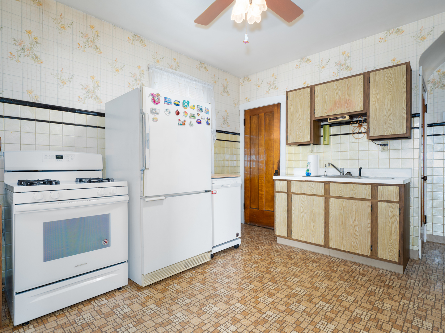 4949 West Deming Place Chicago, IL 60639 - Photo 6 of 18 a kitchen with cabinets and stainless steel appliances