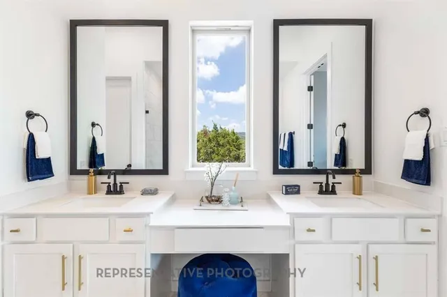 a bathroom with a sink vanity and a mirror