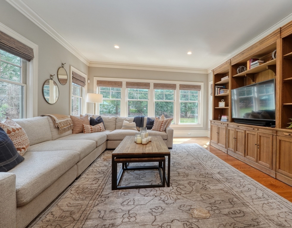 119 Lincoln Road Wayland, MA 01778 - Photo 16 of 40 a living room with furniture a flat screen tv and a window