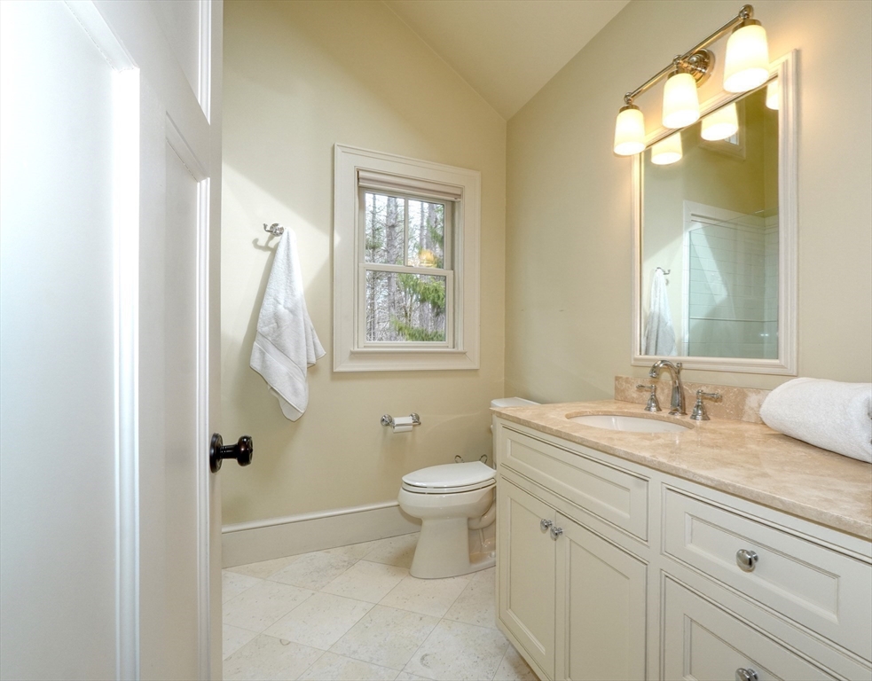 119 Lincoln Road Wayland, MA 01778 - Photo 26 of 40 a bathroom with a granite countertop sink a toilet and a mirror