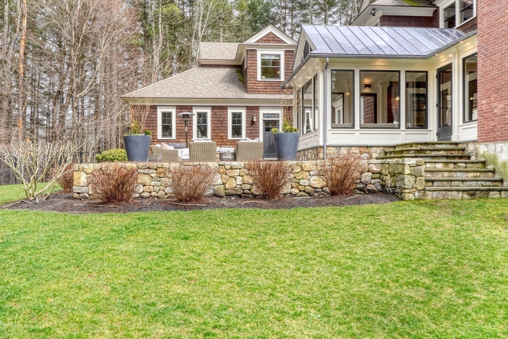 119 Lincoln Road Wayland, MA 01778 - Photo 31 of 40 a front view of a house with a garden