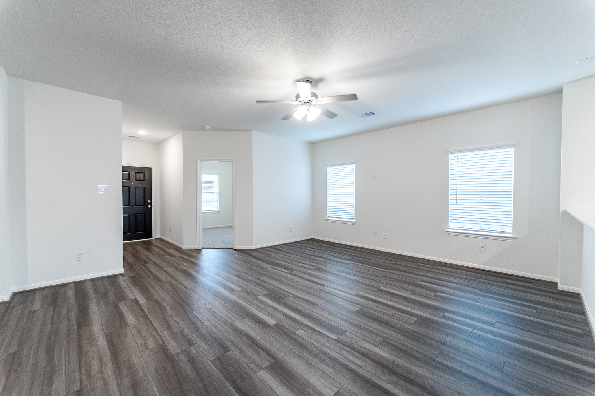 3527 Prairie Rose Trail Angleton, TX 77515 - Photo 7 of 19 a view of an empty room with wooden floor and a window