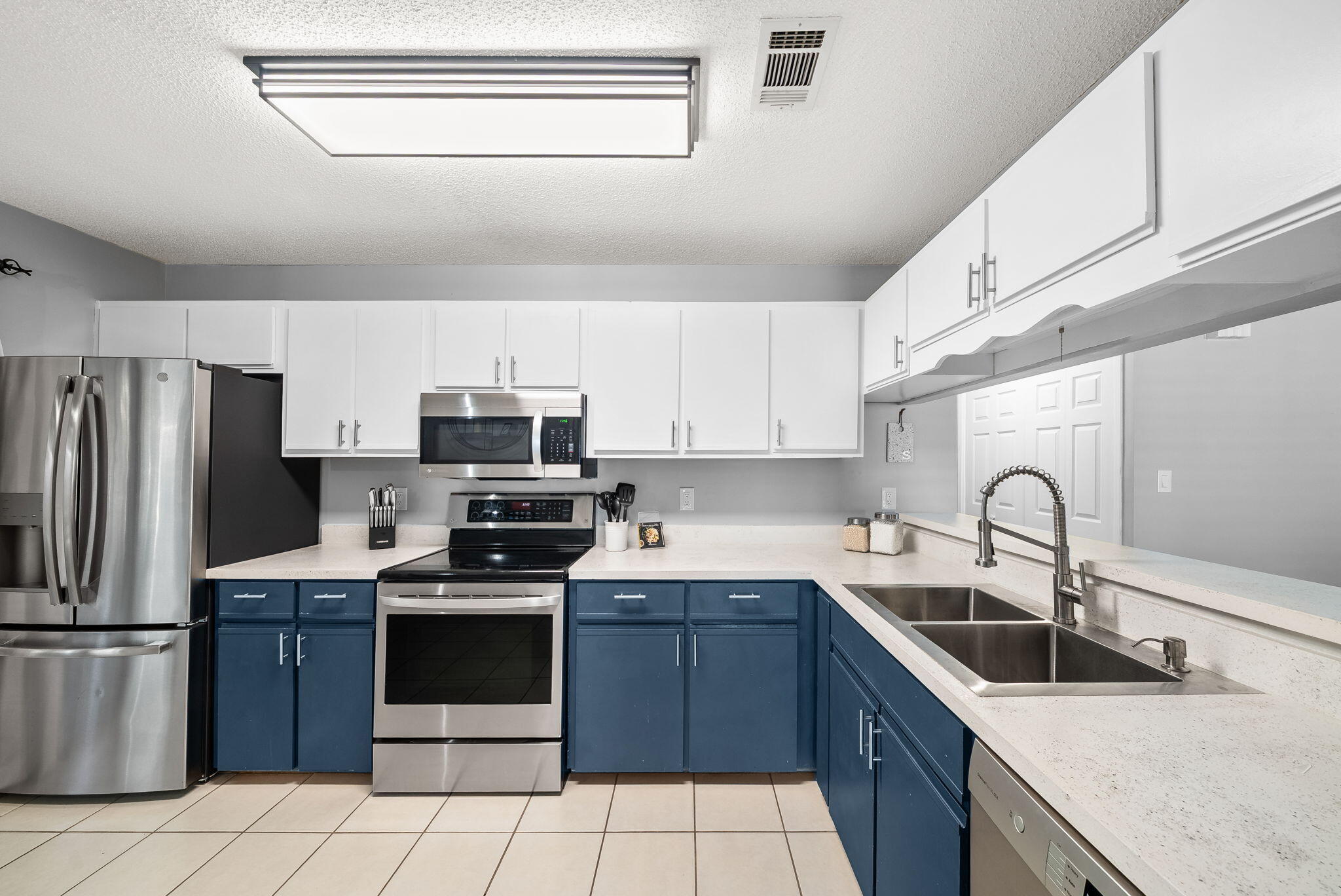 714 Putter Drive Niceville, FL 32578 - Photo 11 of 49 a kitchen with granite countertop a stove sink and refrigerator