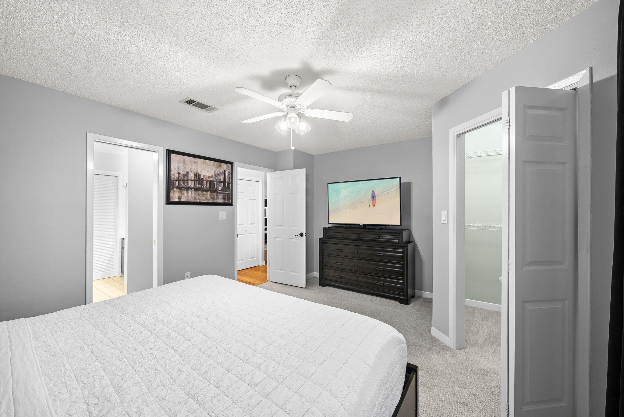 714 Putter Drive Niceville, FL 32578 - Photo 20 of 49 a bedroom with a bed and a chandelier