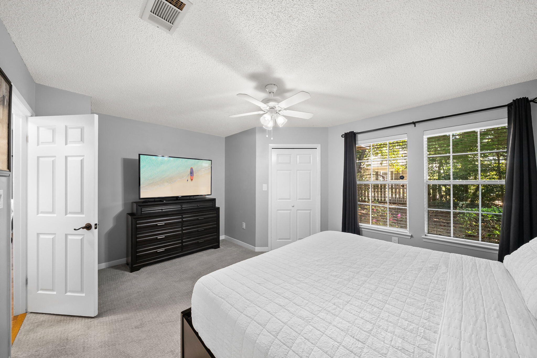 714 Putter Drive Niceville, FL 32578 - Photo 21 of 49 a bedroom with a bed dresser and a window