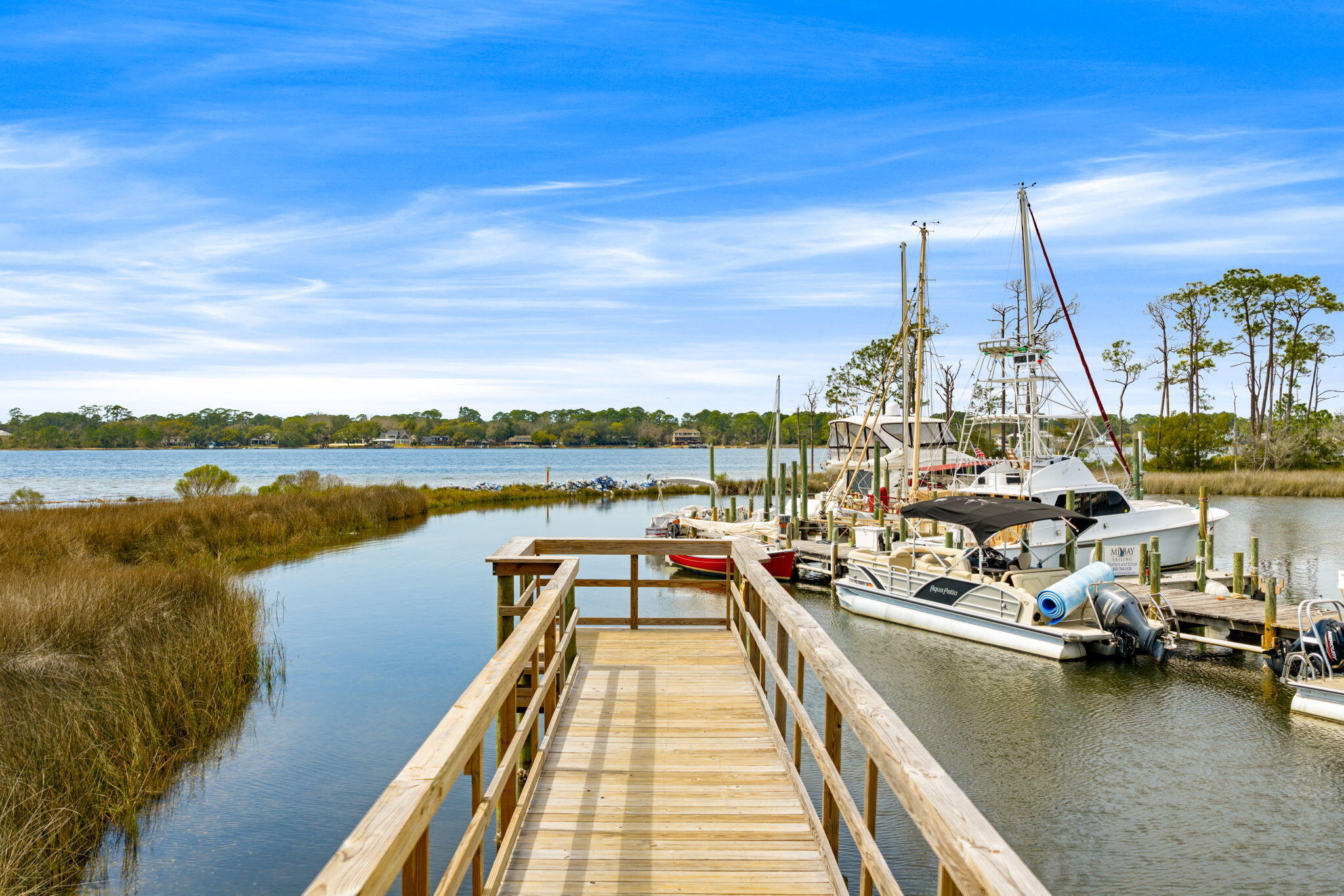 714 Putter Drive Niceville, FL 32578 - Photo 46 of 49 a view of a lake with boats and trees in the background