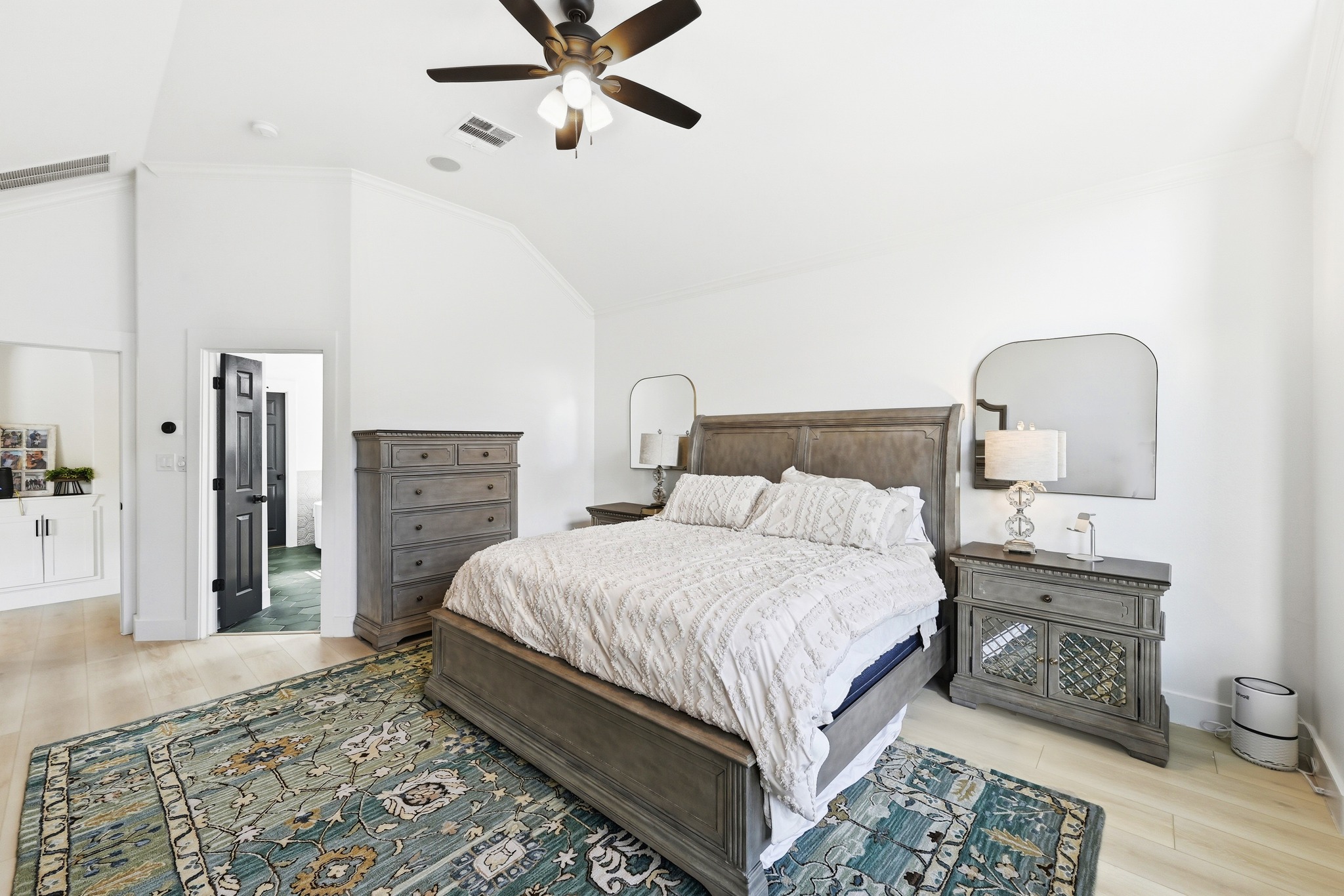 131 Eaton Lane Austin, TX 78737 - Photo 18 of 40 a bedroom with a bed and a chandelier