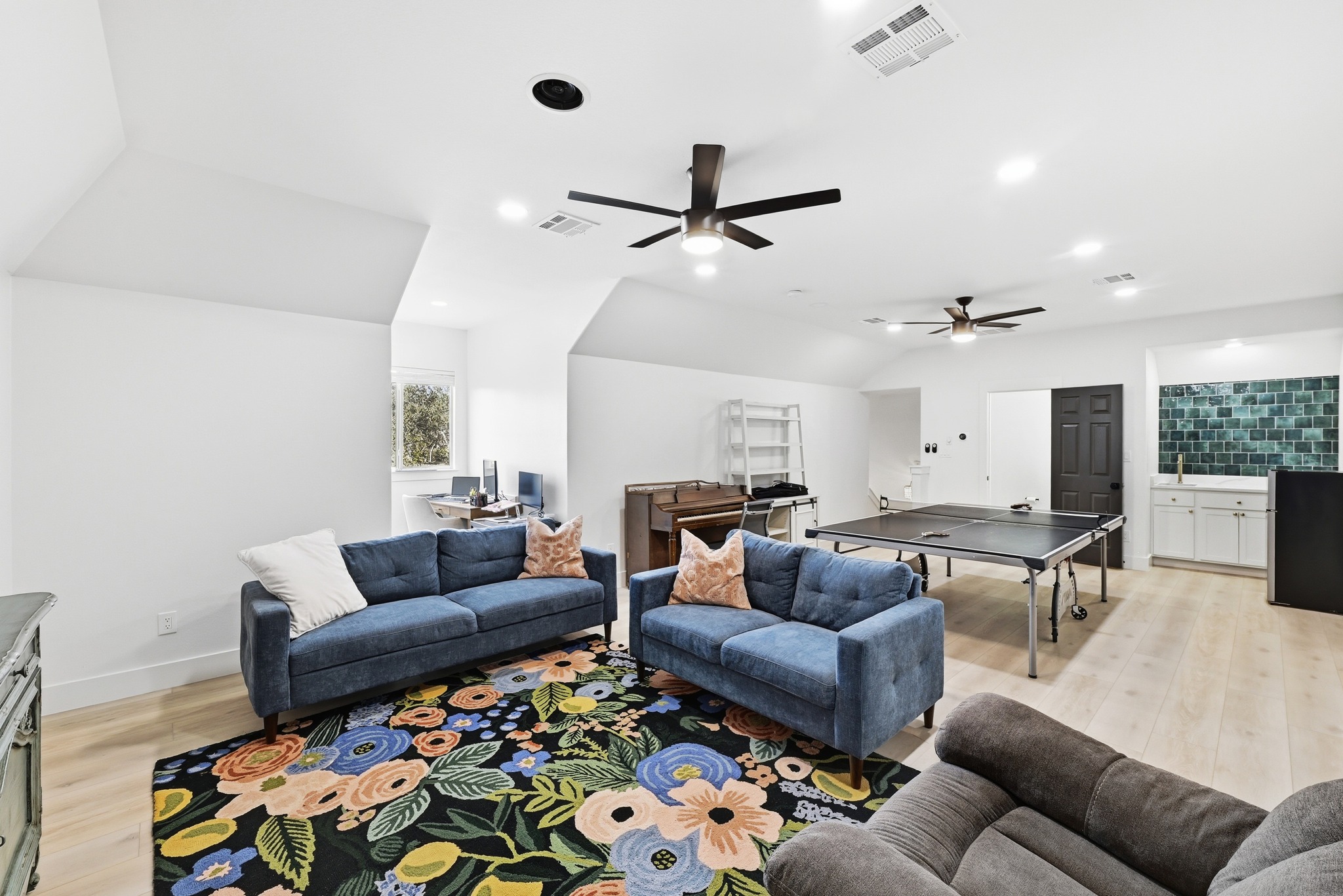 131 Eaton Lane Austin, TX 78737 - Photo 27 of 40 a living room with furniture and a chandelier
