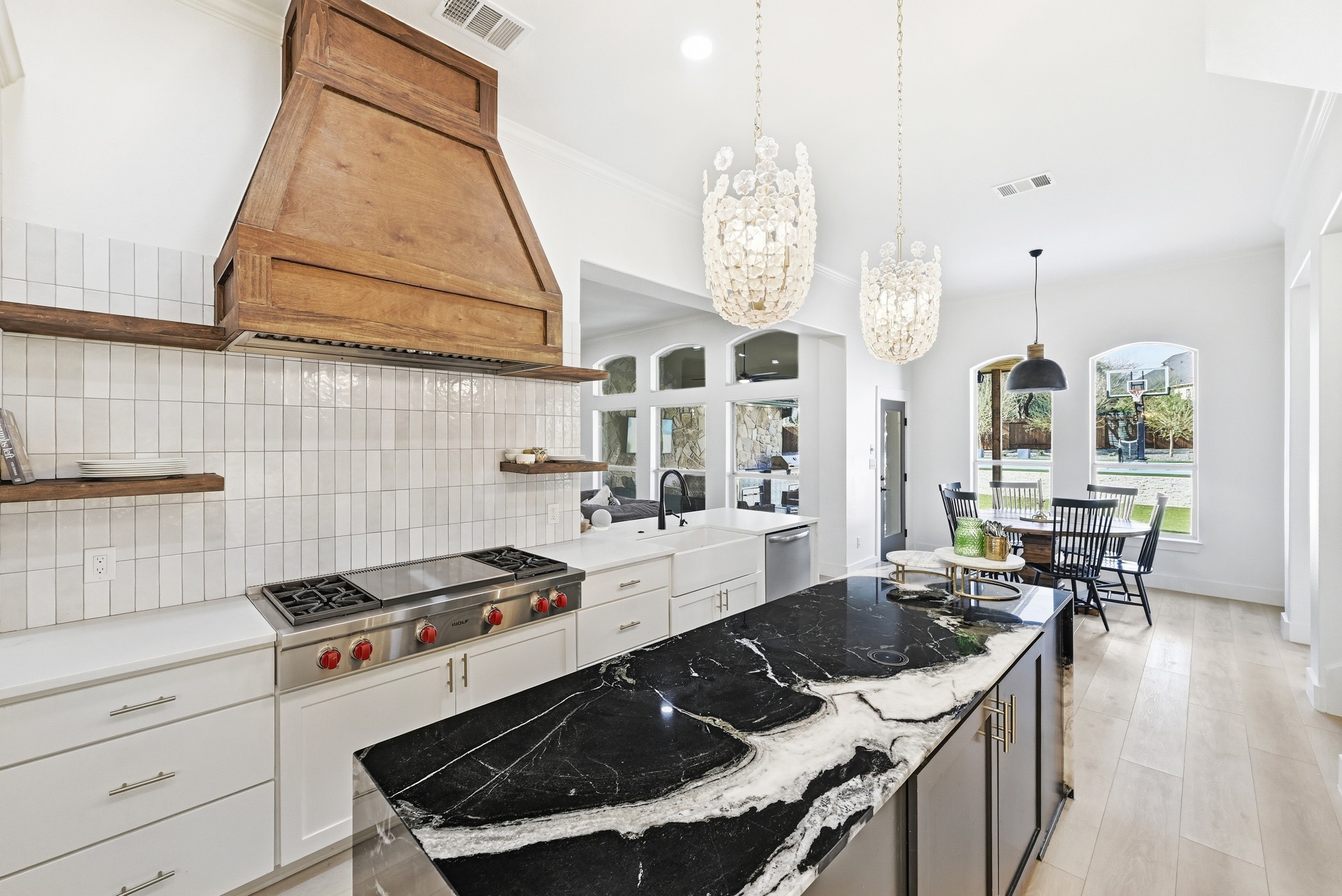 131 Eaton Lane Austin, TX 78737 - Photo 3 of 40 a kitchen with granite countertop a stove a sink a dining table and chairs