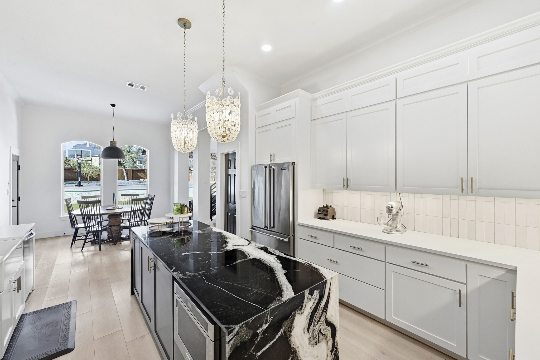 131 Eaton Lane Austin, TX 78737 - Photo 6 of 40 a kitchen with stove a sink and cabinets