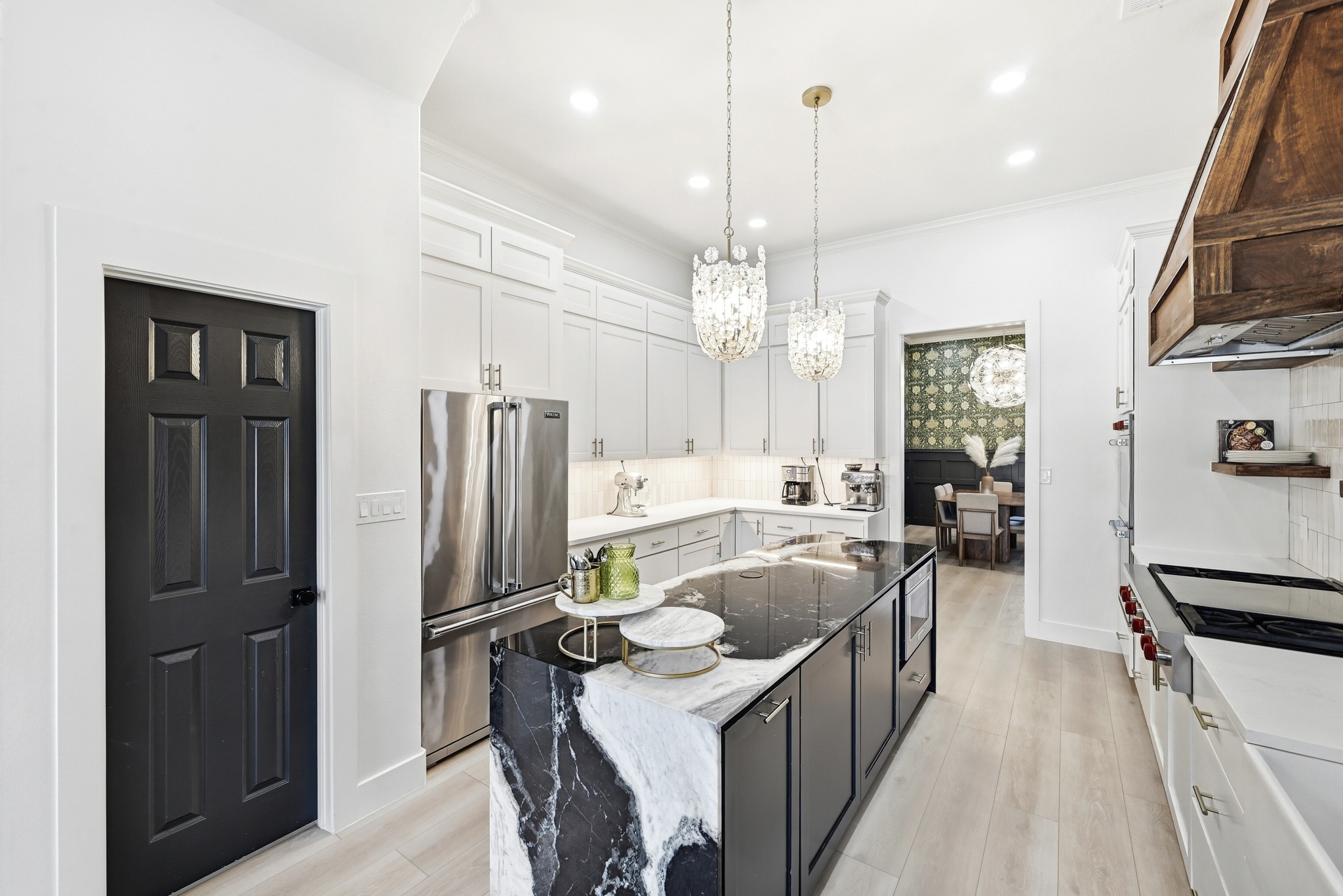 131 Eaton Lane Austin, TX 78737 - Photo 7 of 40 a kitchen with stainless steel appliances granite countertop a refrigerator a sink dishwasher a stove and a dining table with wooden floor
