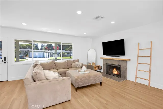 a living room with furniture and a fireplace or television