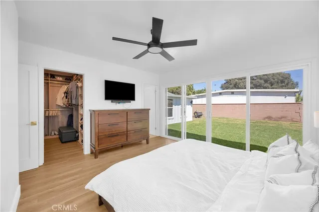 a bedroom with a bed and a television