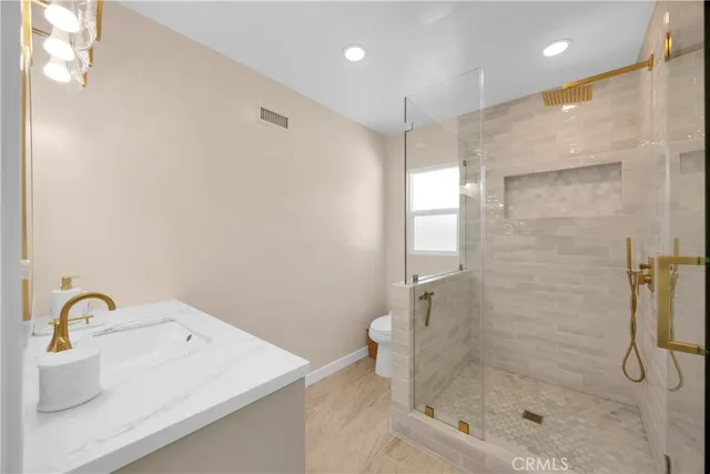 a bathroom with a shower and a sink