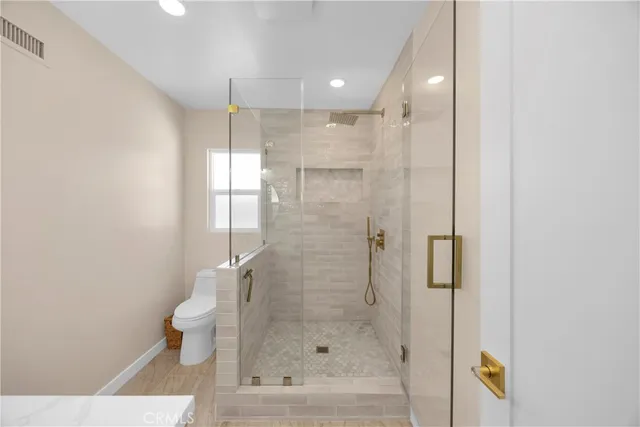 a bathroom with a shower and toilet