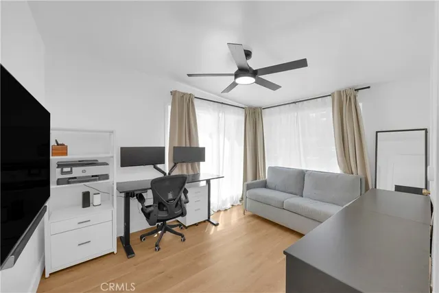 a livingroom with workspace and a couch