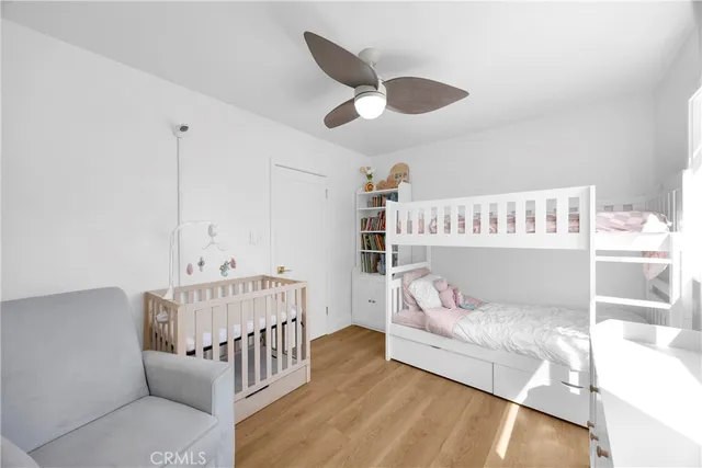 a bedroom with furniture and baby crib