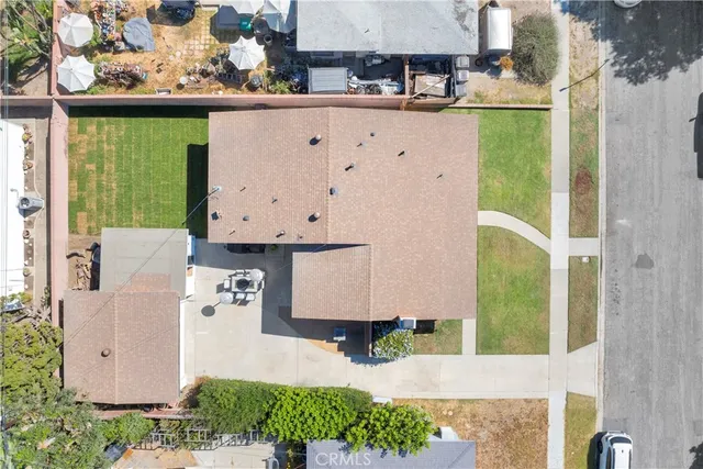 an aerial view of a house with garden space and street view