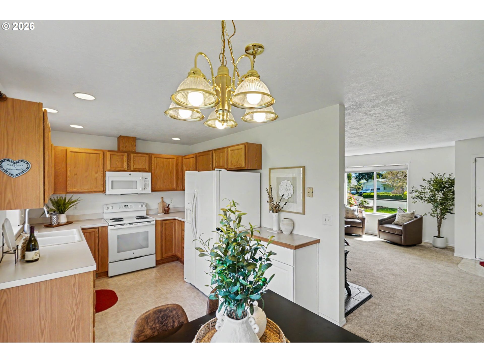 550 Southeast Hankel Street Dallas, OR 97338 - Photo 12 of 36 a view of a dining room with furniture a kitchen and chandelier