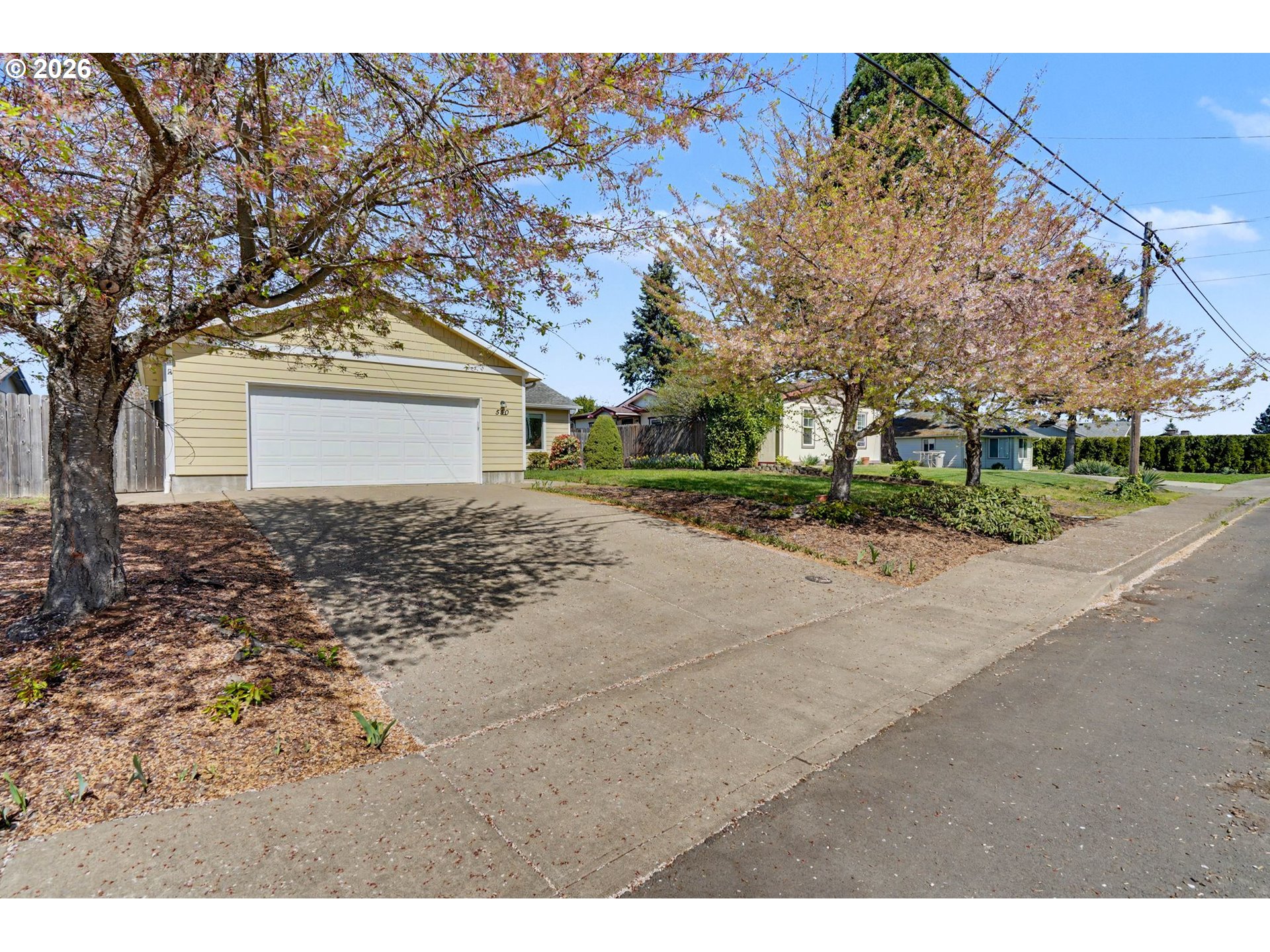550 Southeast Hankel Street Dallas, OR 97338 - Photo 3 of 36 a view of a house with a yard and garage