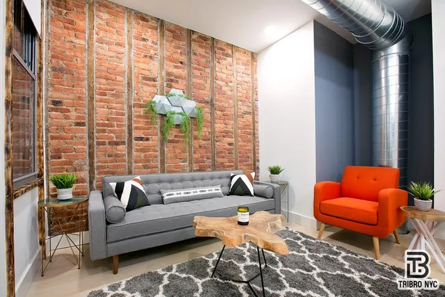 a living room with furniture a rug and a window