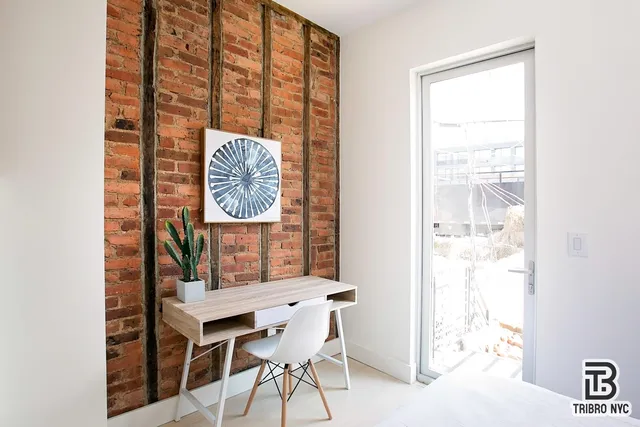 a dining room with furniture and a window
