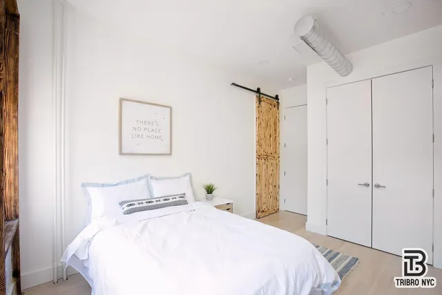 a bedroom with a bed and a table